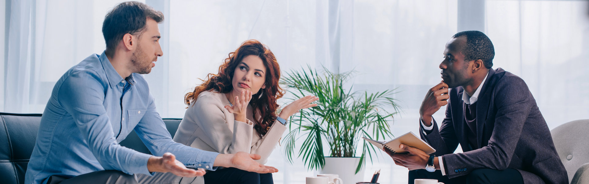 three people talking in a therapy session